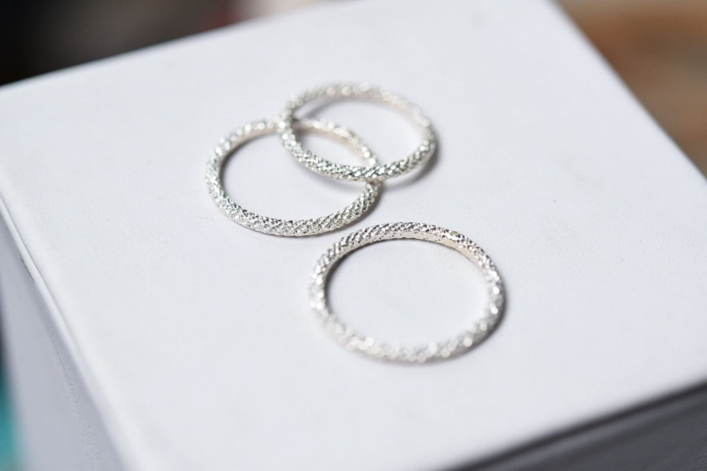 Sterling silver stacking ring with sparkle texture.